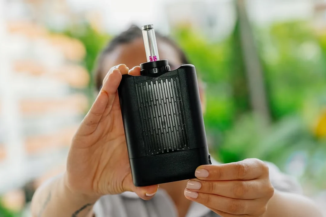 Eine Person hält den Yllvape Angus Enhanced mit Glasaufsatz vor die Kamera